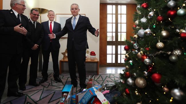 Scott Morrison with Bill Shorten and Greens leader Richard Di Natale at the Kmart Wishing Tree Salvation Army collection in the Prime Minister’s office yesterday. Picture Gary Ramage.