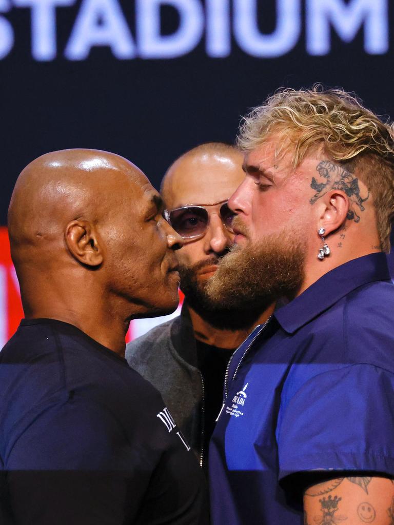 Mike Tyson and Jake Paul face off. (Photo by Kena Betancur / AFP)