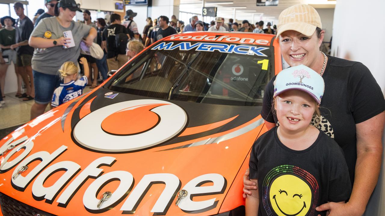 Heidi (back) and Charli Gander with a Jamie Whincup race car as V8 Supercars team Red Bull Ampol Racing launch their 2024 livery at Toowoomba Wellcamp Airport, Saturday, February 3, 2024. Picture: Kevin Farmer