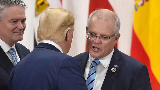 Prime Minister Scott Morrison (R) chats with US President Donald Trump (C) at the G20 Summit in Osaka, Japan.