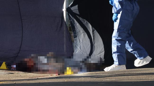 Forensic police examined the body, which remained on the street on Thursday morning. Picture: NCA NewsWire