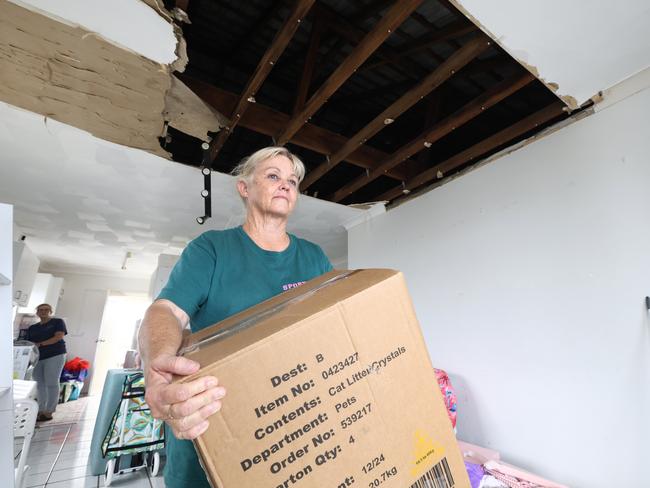 Janine Pirie cleans up in her damaged unit. Picture: David Clark