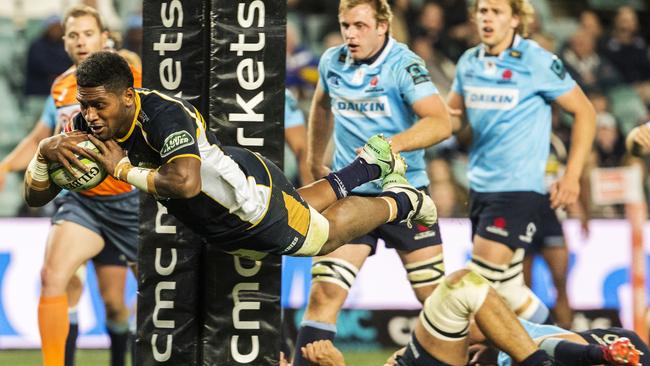 Isi Naisarani of the Brumbies launches himself over the tryline against the Waratahs on Saturday night.