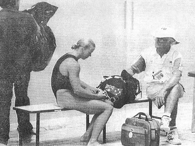 Don’t trash-talk yourself … Lisa Curry being reassured by Joe King at the 1992 Barcelona Olympics, as a cleaner takes the rubbish out. Photo courtesy Lisa Curry, from her memoir Lisa.