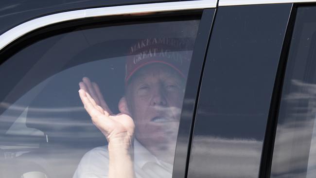 President Donald Trump waves from his limousine as he leaves Trump International Golf Club, Sunday, March 16. Picture: AP Photo/Manuel Balce Ceneta