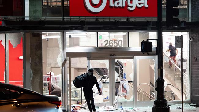 A looter robs a Target store amid protests in Oakland, California at the weekend. Picture: AFP