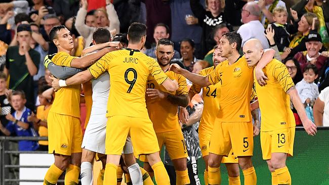 Massimo Luongo of Australia is congratulated by team mates after scoring.