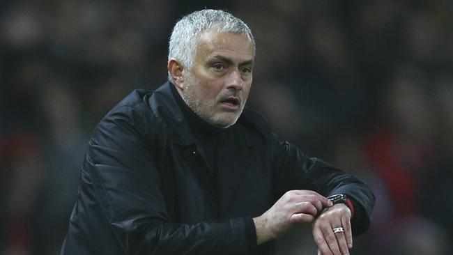 Manchester United's coach Jose Mourinho sets the extra time during the English Premier League soccer match between Manchester United and Arsenal at Old Trafford stadium in Manchester, England, Wednesday Dec. 5, 2018. (AP Photo/Dave Thompson)