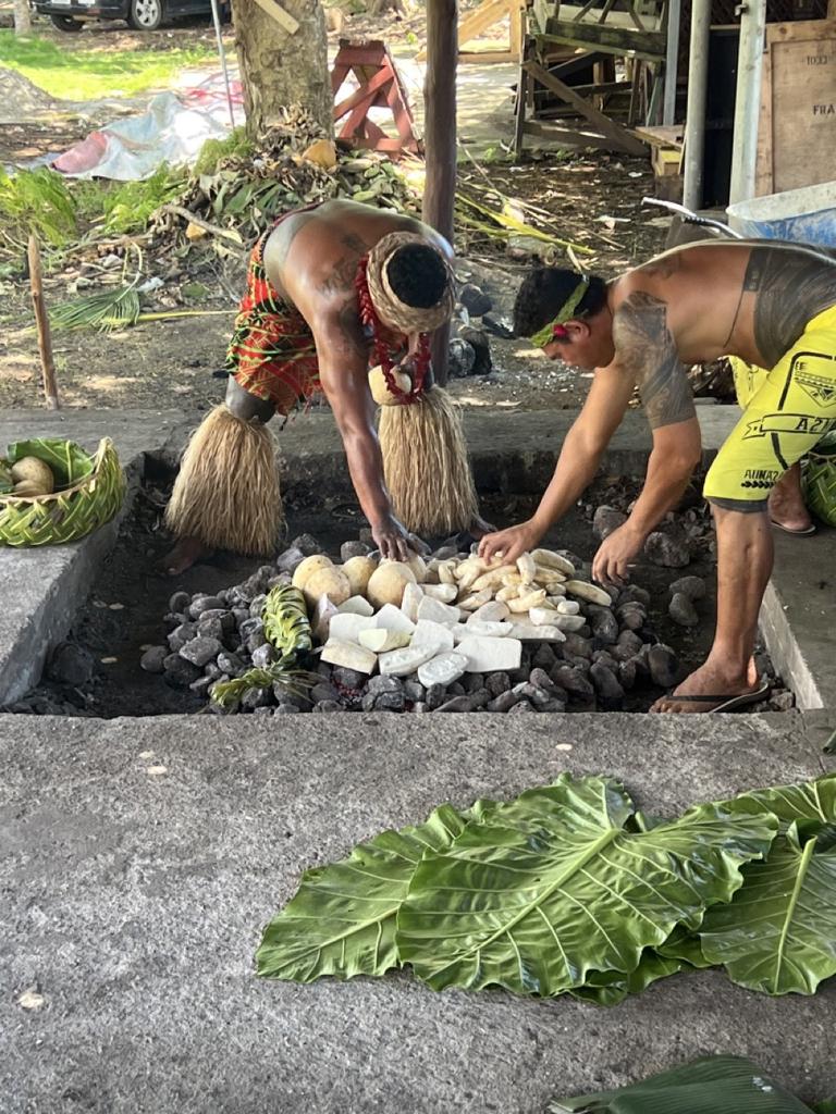 Food is placed in the umu before banana leaves are placed on top to trap in the heat. Pic: Supplied