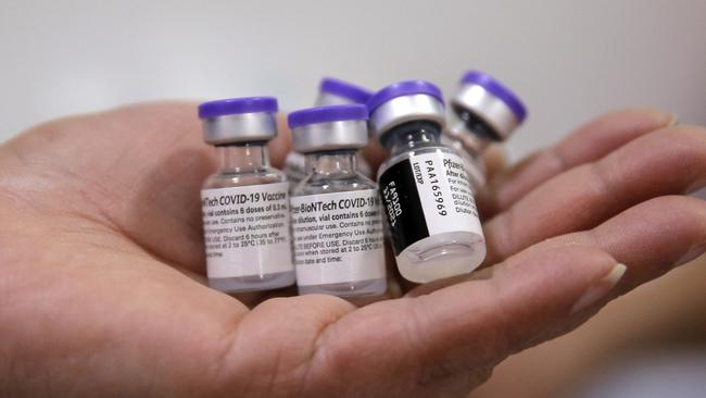A health workers holds vials of the Pfizer-BioNTech vaccine in Santiago. Picture: AFP.