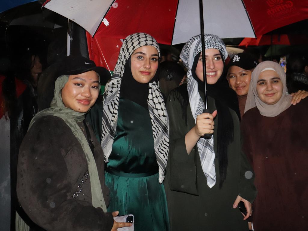 Protesters gathered at Surfers Paradise Esplanade despite torrential rain to call for an immediate ceasefire of bombing in the Gaza Strip. Picture: Amaani Siddeek