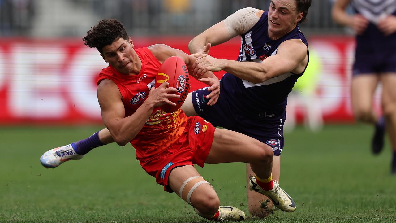 PERTH, AUSTRALIA - JUNE 23: Jordan Clark of the Dockers tackles Jake Rogers of the Suns during the round 15 AFL match between Fremantle Dockers and Gold Coast Suns at Optus Stadium, on June 23, 2024, in Perth, Australia. (Photo by Paul Kane/Getty Images)