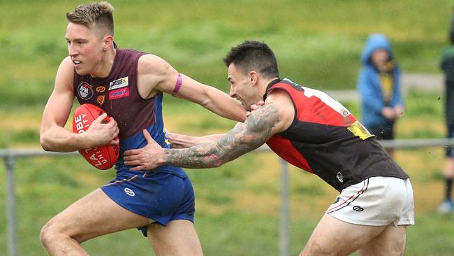 Banyule’s Reuben Blackmore-Moore tries to fend off Mikael Avramov of Eltham. Picture: Hamish Blair