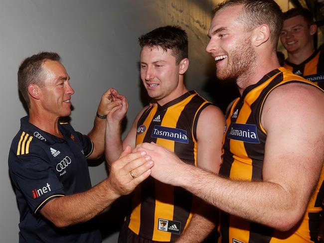 Hawthorn coach Alastair Clarkson celebrates with Liam Shiels and Tom Mitchell.