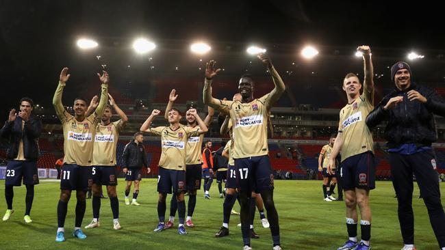 Newcastle Jets players celebrate with fans after beating Brisbane Roar 2-1. Picture: Ashley Feder / Getty Images