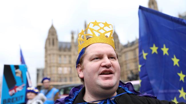 A pro-EU demostrator wears headgear featuring the EU outside the Houses of Parliament in central London on April 2, 2019. - British Prime Minister Theresa May chairs a crucial meeting of senior ministers on Tuesday to seek a way out of a months-long Brexit deadlock, as the EU warned a no-deal departure from the bloc is growing more likely by the day. (Photo by ISABEL INFANTES / AFP)