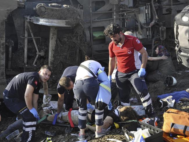 Emergency services rescue victims from overturned train cars near a village in Turkey where at least 10 people were killed and 73 injured. Picture: Mehmet Yirun/DHA-Depo/AP