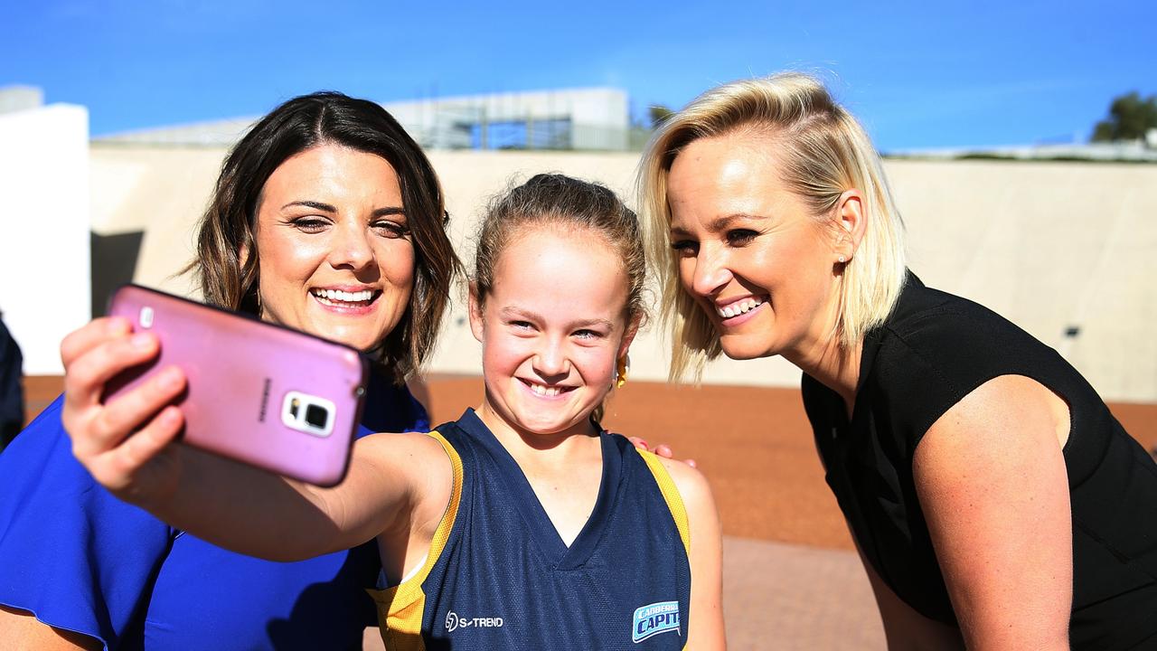 Fox Sports' presenters Kelli Underwood and Jess Yates with a young fan at Parliament House in Canberra.