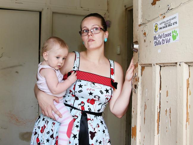 Amanda Shanahan, with her daughter Ava, 11 months, at her rental property, The Entrance. Amanda's house has several defects and dangerous hazards, that the landlord has refused to fix. Picture:Peter Clark