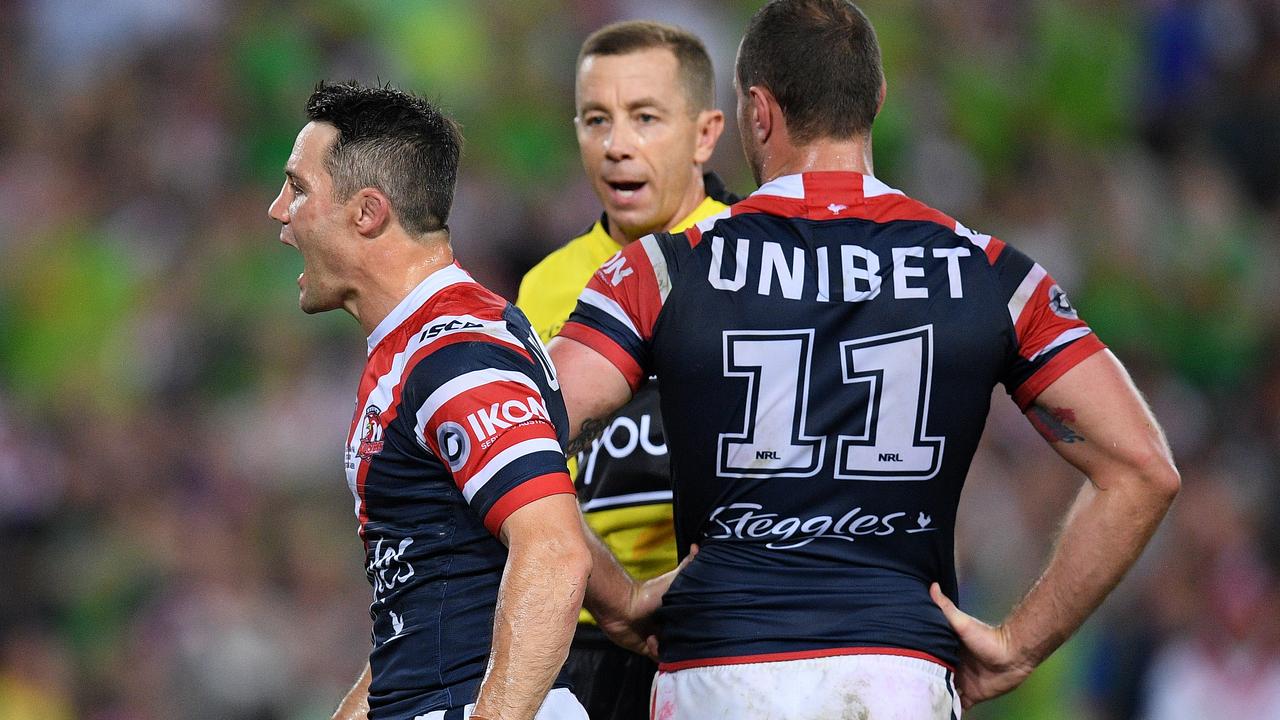 Cooper Cronk of the Roosters (left) reacts as he is sent to the sin bin