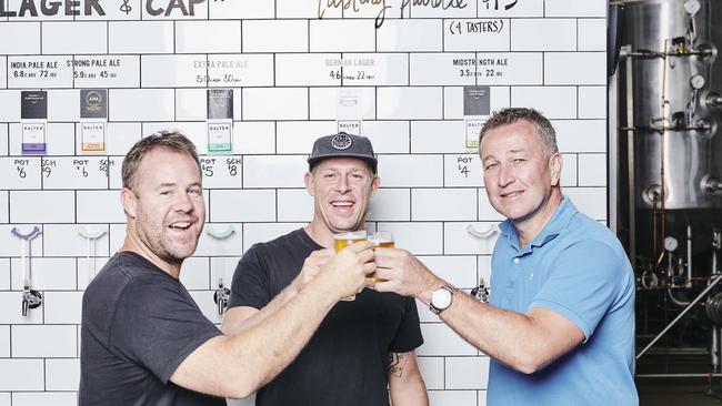 Ant Macdonald, Mick Fanning and CUB CEO Peter Filipovic celebrating the Balter Brewery deal.