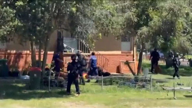 Heavily armed police during the standoff in West Kempsey. Picture: NBN