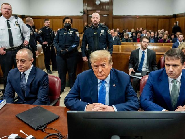 Former US President Donald Trump, sitting with attorneys Emil Bove (L) and Todd Blanche (R), has looked disgruntled, and complained of the cold courtroom. Picture: AFP