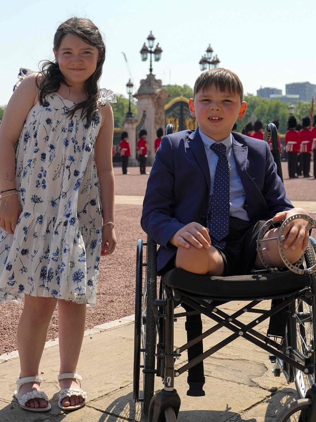 Tony Hudgell and Lyla O'Donovan watched the Changing of the Guard ahead of a private tea party. Picture: Buckingham Palace/AFP