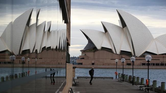 A lone skateboarder on Sydney’s harbour foreshore following a localised lockdown announcement on Friday.