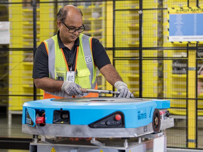 Robots transport inventory directly to a storage system or to an employee picking out items for a customer order at Amazon’s fulfilment centre in Kemps Creek, Sydney.