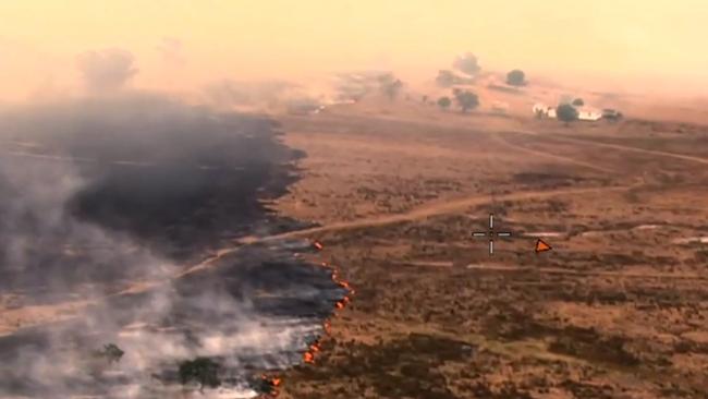 The fire burns close to homes at Wallangarra. Picture: QFES