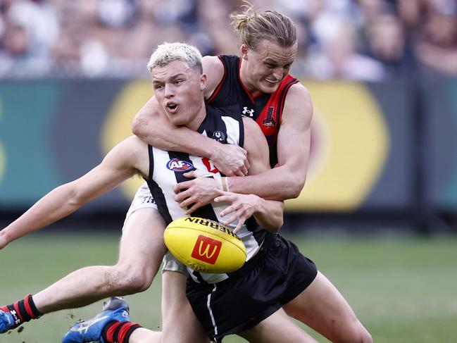 *APAC Sports Pictures of the Week - 2022, July 25* - MELBOURNE, AUSTRALIA - JULY 24: Mason Redman of the Bombers  tackles Jack Ginnivan of the Magpies during the round 19 AFL match between the Collingwood Magpies and the Essendon Bombers at Melbourne Cricket Ground on July 24, 2022 in Melbourne, Australia. (Photo by Darrian Traynor/Getty Images)