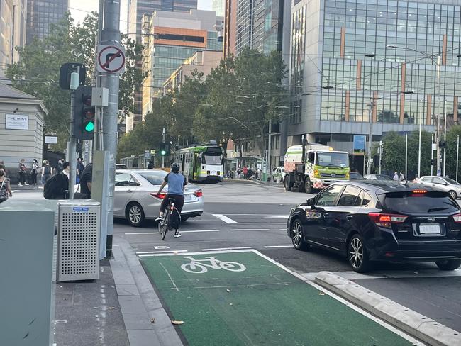 A cyclist is blocked off by a motorist at the corner of Latrobe and William St, Melbourne. Picture: Ed Bourke