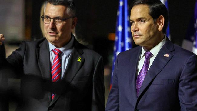 TOPSHOT - Israel's Foreign Minister Gideon Saar (L) welcomes US Secretary of State Marco Rubio upon arrival at Israel's Ben Guiron Airport in Lod on February 15, 2025 on the first leg of his Middle East trip. (Photo by Evelyn Hockstein / POOL / AFP)