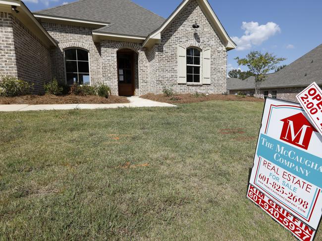 FILE - In this Sept. 25, 2019 file photo, a sign promoting an open house sits atop a realty company's lawn sign in Brandon Miss.  Long-term U.S. mortgage rates were mostly steady, Thursday, June 11, 2020, continuing to hover near all-time lows. Mortgage buyer Freddie Mac reports that the average rate on the benchmark 30-year home loan edged up to 3.21% from 3.18% last week.  .(AP Photo/Rogelio V. Solis, File)