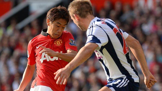 Manchester United's Japanese midfielder Shinji Kagawa takes on West Bromwich Albion defender Gareth McAuley at Old Trafford before being substituted