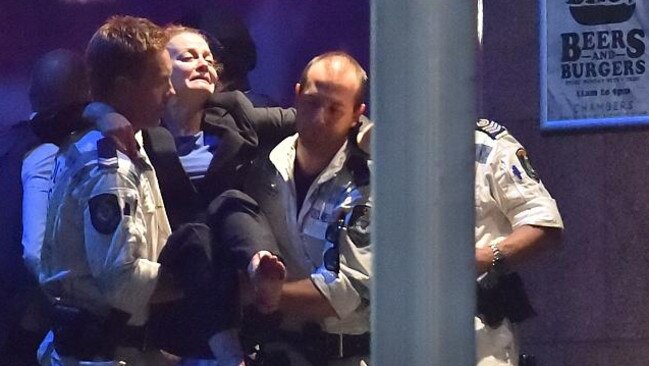 An injured hostage is carried out of a cafe in the central business district. Picture: AFP