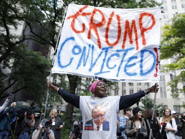 TOPSHOT - People react after former US President and Republican presidential candidate Donald Trump was convicted in his criminal trial outside of Manhattan Criminal Court in New York City, on May 30, 2024. A New York jury convicted Donald Trump on all charges in his hush money case on May 30, 2024 in a seismic development barely five months ahead of the election where he seeks to recapture the White House. (Photo by Kena Betancur / AFP)