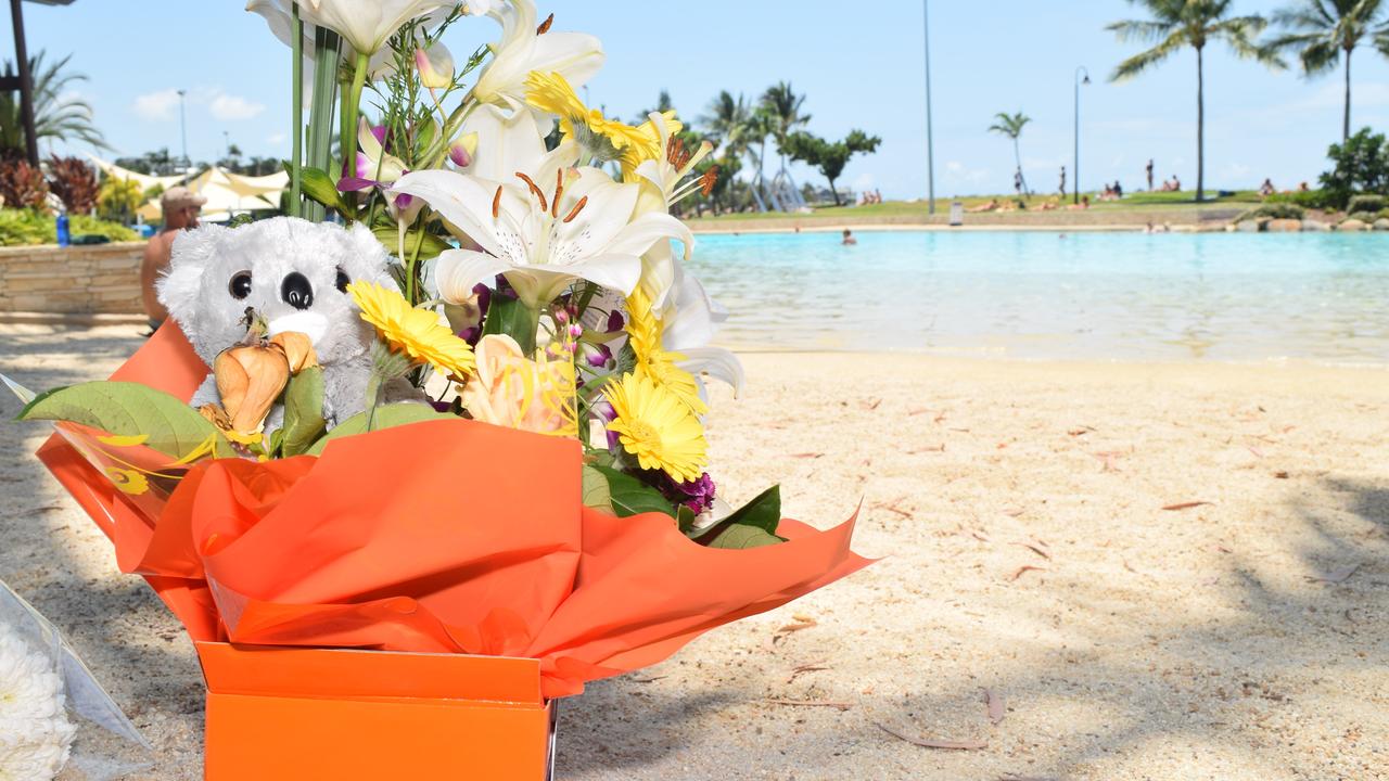 Tributes were left at Airlie Beach Lagoon after a 30-year-old Chinese man and his five-year-old son drowned.