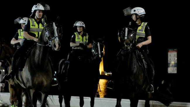 Mounted units at St Kilda Beach last night. Picture: Andrew Henshaw