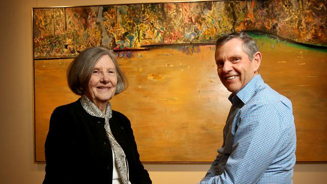 Lyn Williams, widow of the late Fred Williams, with Philip Bacon from Brisbane’s Philip Bacon Galleries, in front of a 1974 painting titled ‘Forest Pond.’ The Fred Williams painting sold for almost $3 million in Brisbane in 2018. Picture: Steve Pohlner/AAP.