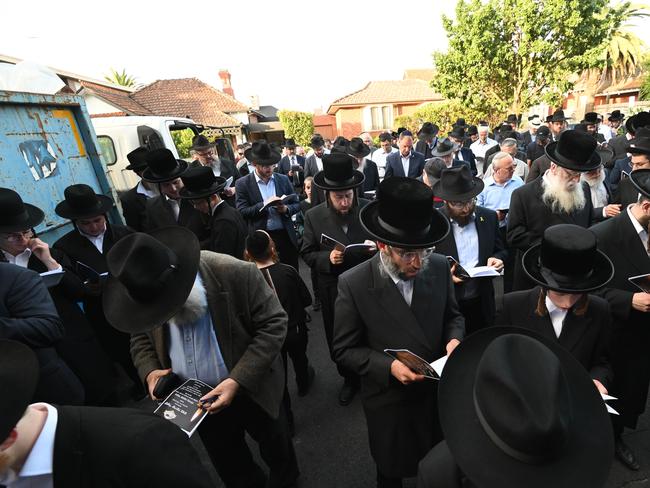 The community farewelled the damaged holy books and scriptures. Picture: Tony Gough