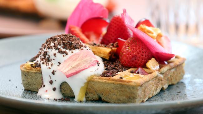 Gluten-free buckwheat waffle with seasonal strawberries, plum, coconut and cocoa. Photo by Richard Gosling