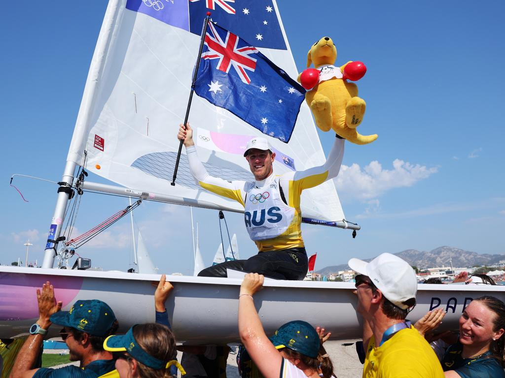 Matt Wearn celebrates with friends and teammates after winning the gold medal in the men's dinghy ILCA class in Marseille. Picture: Alex Livesey/Getty Images