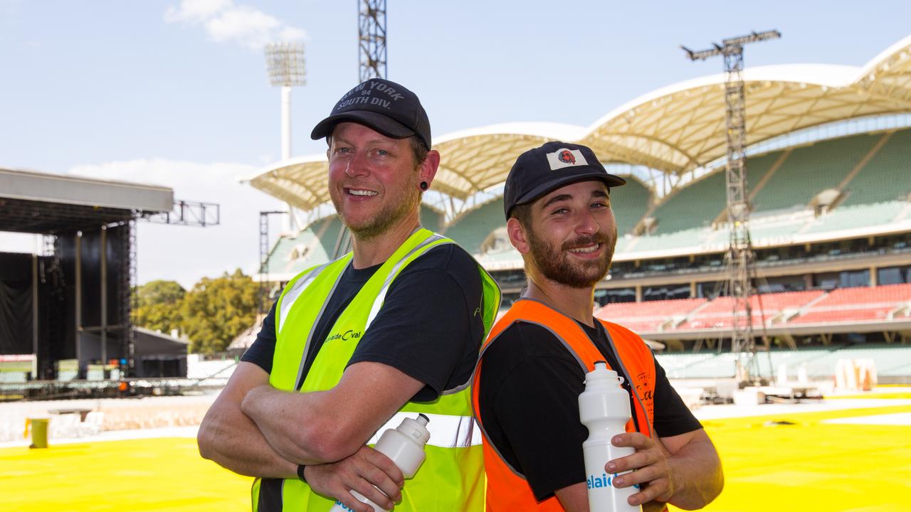 Scott Black and Jordan Jackson sweating it out while setting up the stage for the Phil Collins concert in 46 degree heat. Picture: Elise Partington