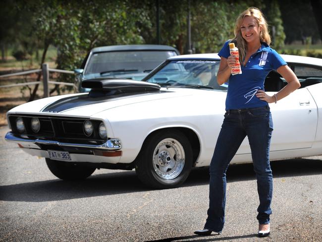 Australian radio presenter Amber Petty with a Ford Muscle Car eating a Chicko Roll after a bet with Eric Bana.