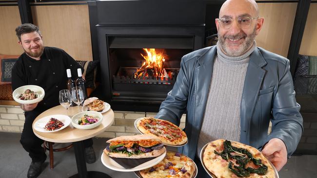 Tony Donnini and Sam Green with pizzas and salads at Crudo. Picture: David Caird