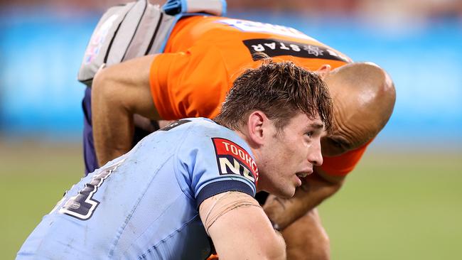 TOWNSVILLE, AUSTRALIA - JUNE 09: Cameron Murray of the Blues is attended to by a trainer during game one of the 2021 State of Origin series between the New South Wales Blues and the Queensland Maroons at Queensland Country Bank Stadium on June 09, 2021 in Townsville, Australia. (Photo by Mark Kolbe/Getty Images)