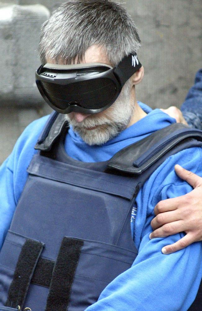 Fourniret wears a blindfold and bulletproof vest after being questioned. Picture: AFP