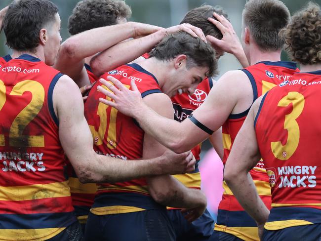 Billy Dowling from the Crows (centre) celebrates a goal with team mates during the Round 17 SANFL match between Sturt and Adelaide at Unley Oval in Adelaide, Saturday, August 19, 2023. (SANFL Image/David Mariuz)